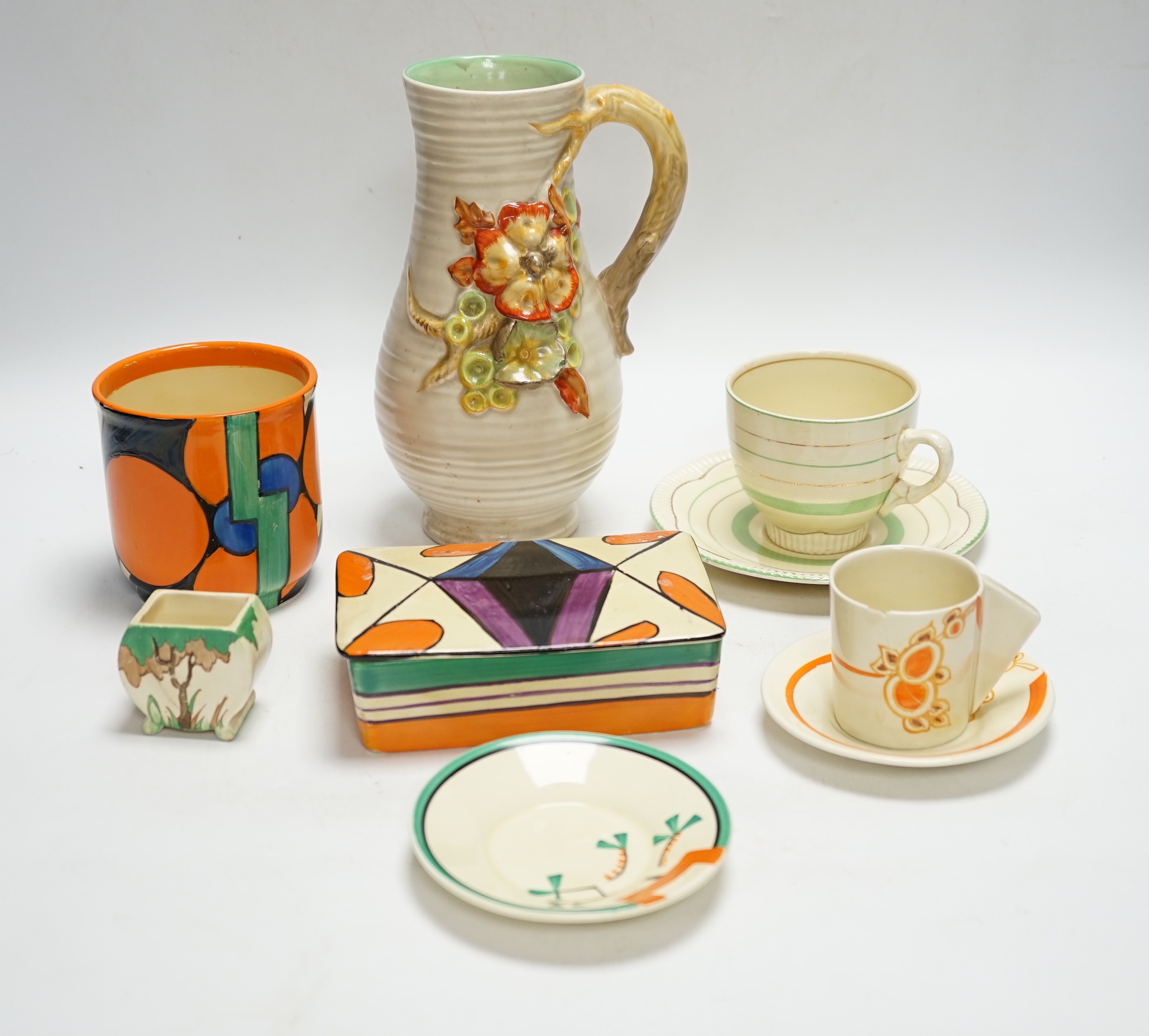 A Clarice Cliff Fantasque butter dish and cover, a Bizarre pot and five other Clarice Cliff items, tallest 20.5cm high
